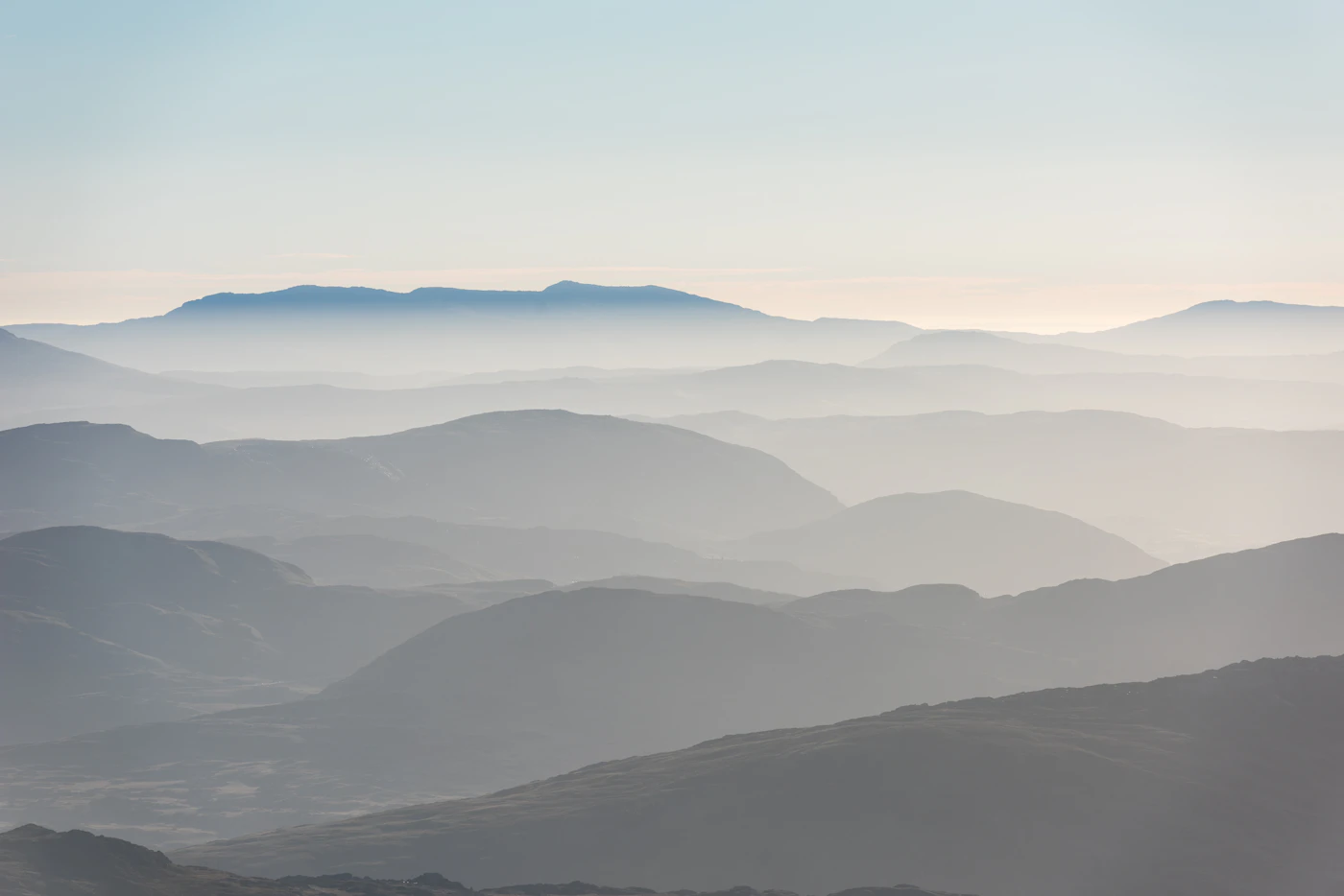 Layered mountain ridges fading into distant haze